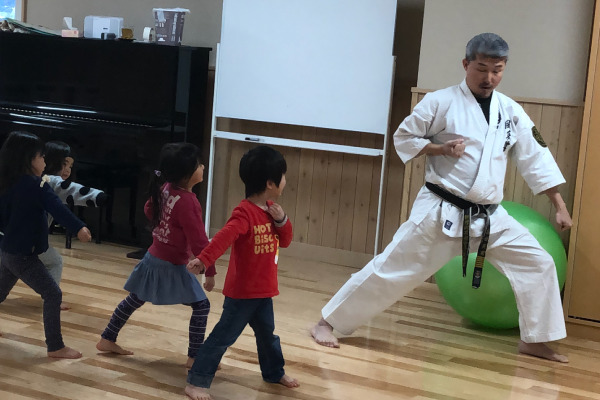 空手の先生と稽古をする子どもたち